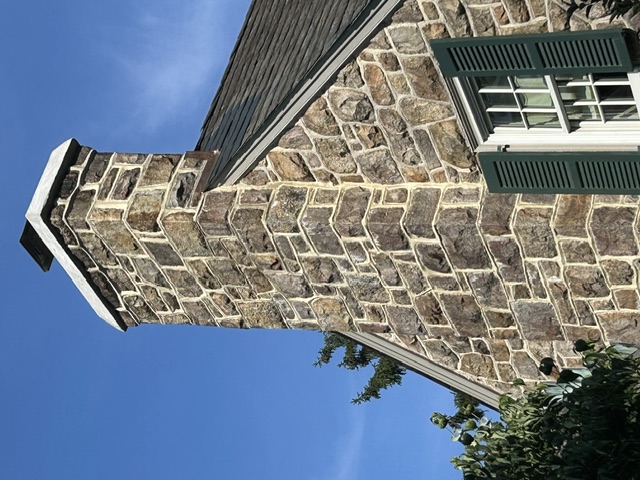 Close-up of hand-laid stone chimney with tight mortar joints