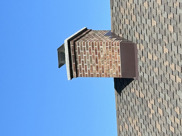 Rebuilt brick chimney with stainless steel liner and cap